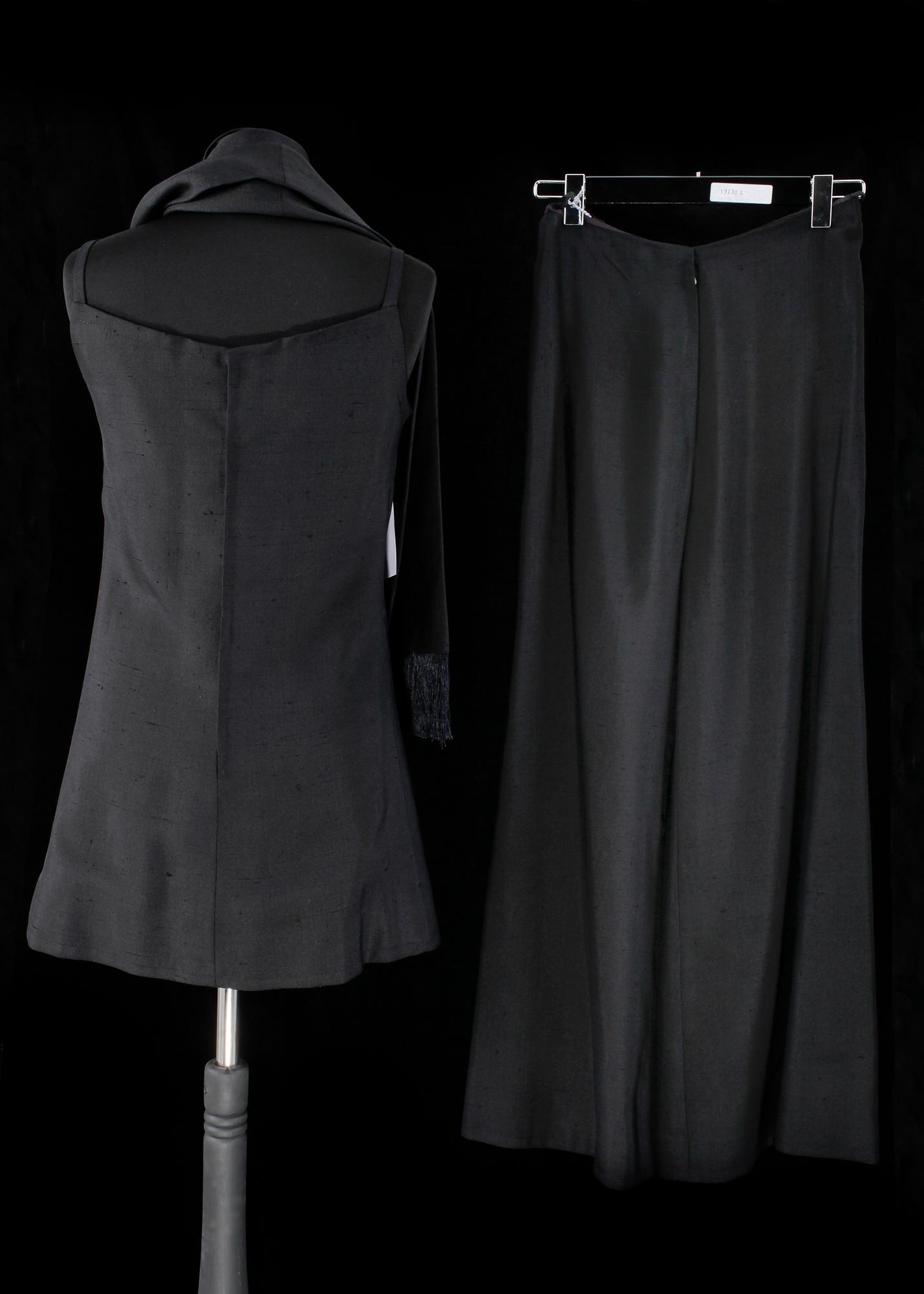 A black three-piece 1960s/70s ensemble consisting of trousers, top and scarf by Christian Dior.