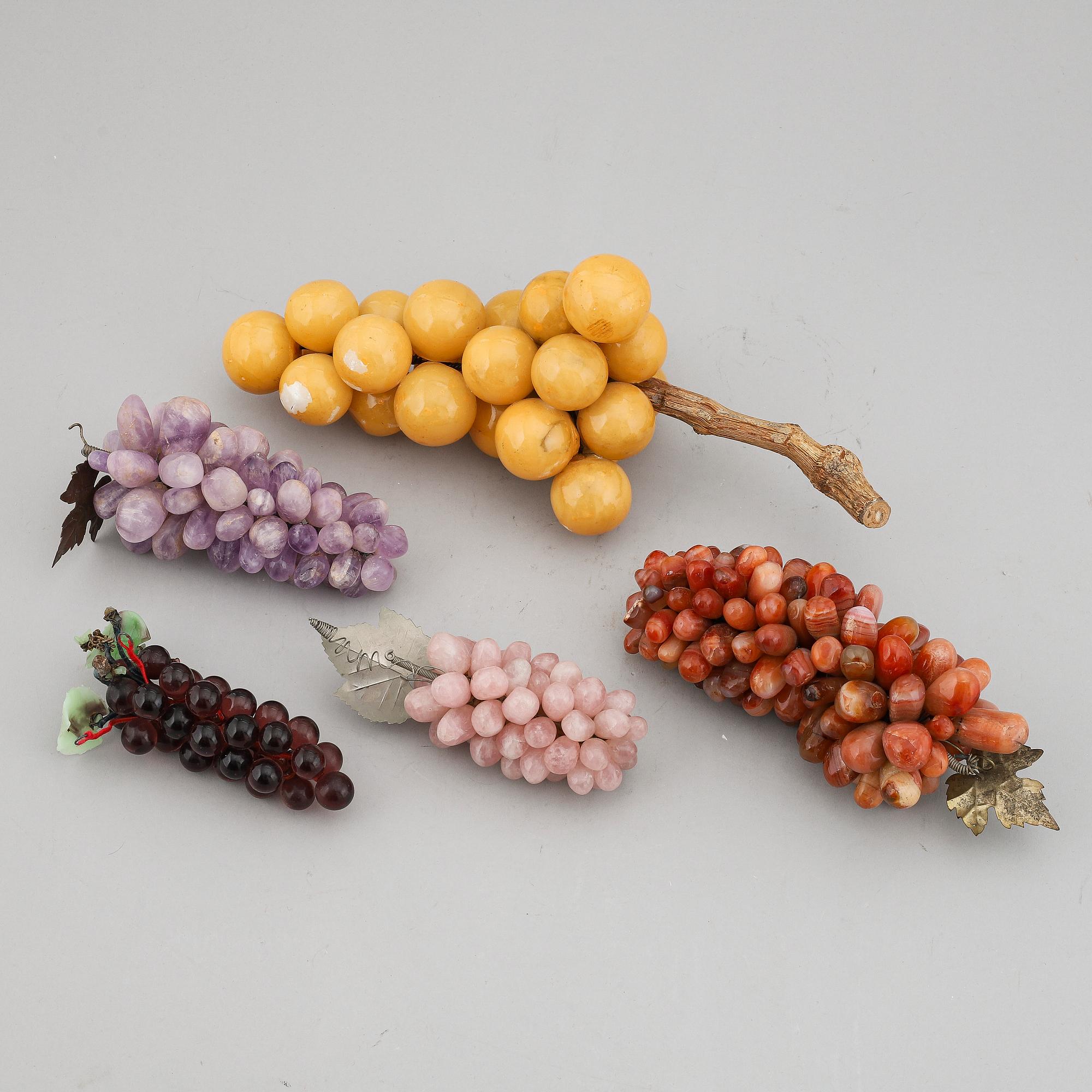 A group of five glass and stone objects, in shapes of fruits, 20th century.