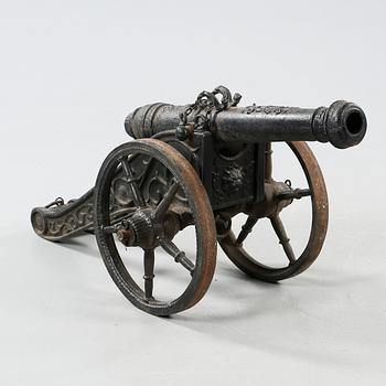 A small cast iron cannon, 19th or early 20th century.