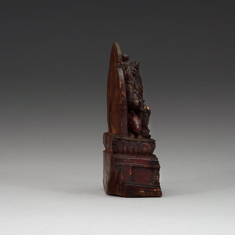 A carved wooden figure on Ganesha on a throne, Nepal, 19th Century or older.