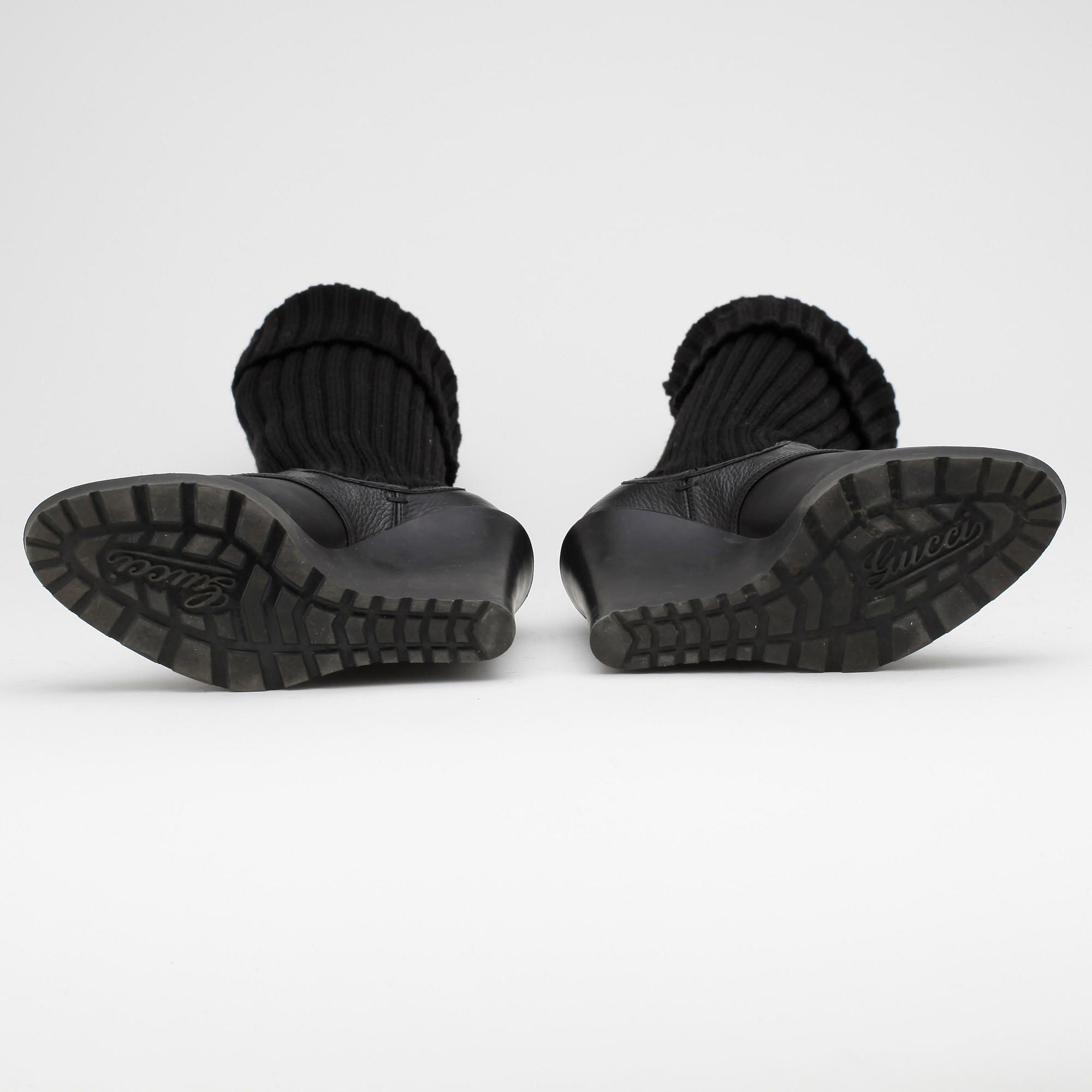 GUCCI, a pair of black leather boots.