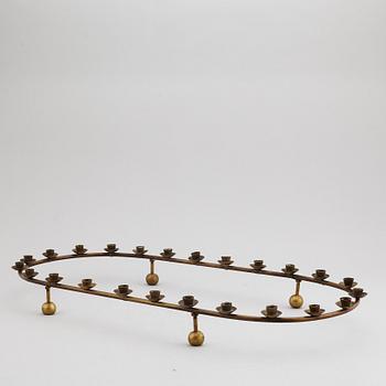 A mid 20th Century brass candle ring.