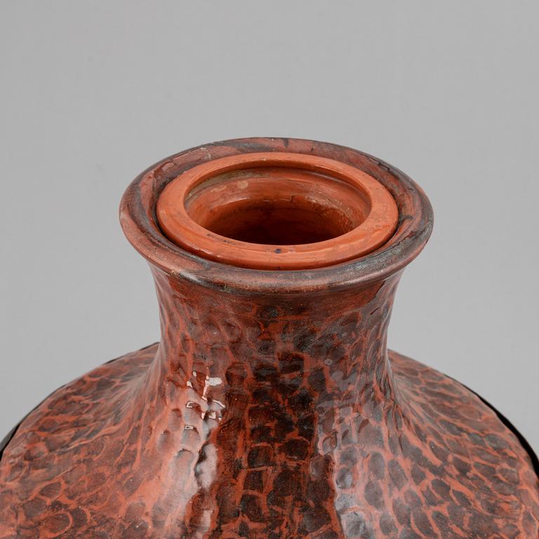 A large earthenware and copper vase, easy 20th century.