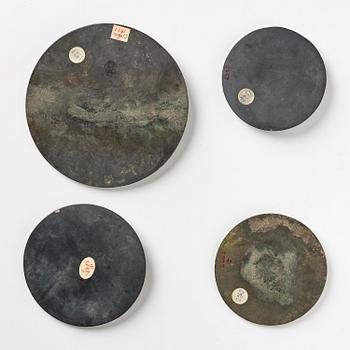 Four silvered bronze mirrors, Han dynasty (220 B.C. - 206 A.D).