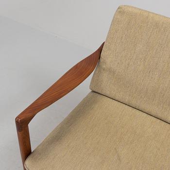 a 1960s teak "Kandidaten" armchair designed by IB Kofod Larsen for OPE Möbler, Jönköping.