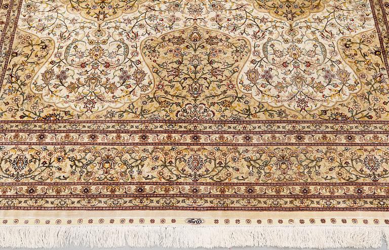 An oriental silk carpet, c. 279 x 184 cm.