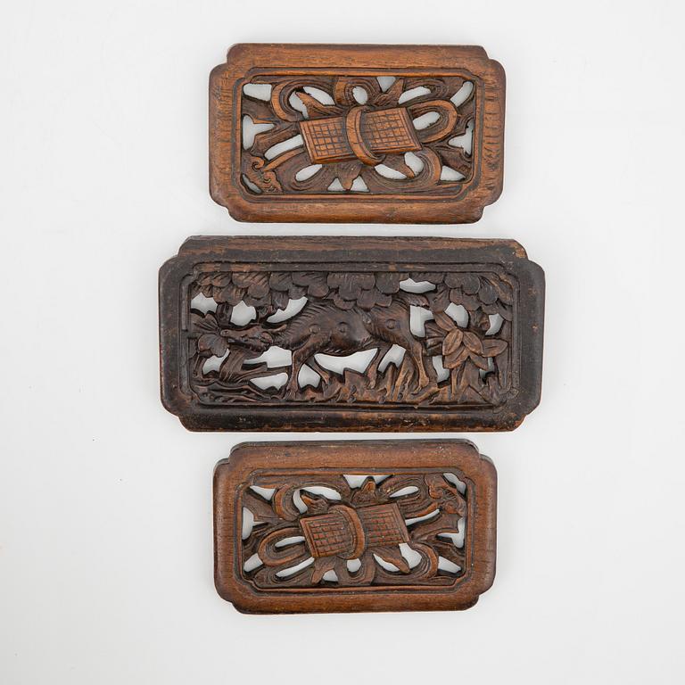 A carved wooden box, a ladle and three placques, Jakarta, Indonesia, 20th Century.