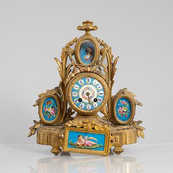 A Louis XVI style mantel clock and a pair of candelabra, circa 1900.