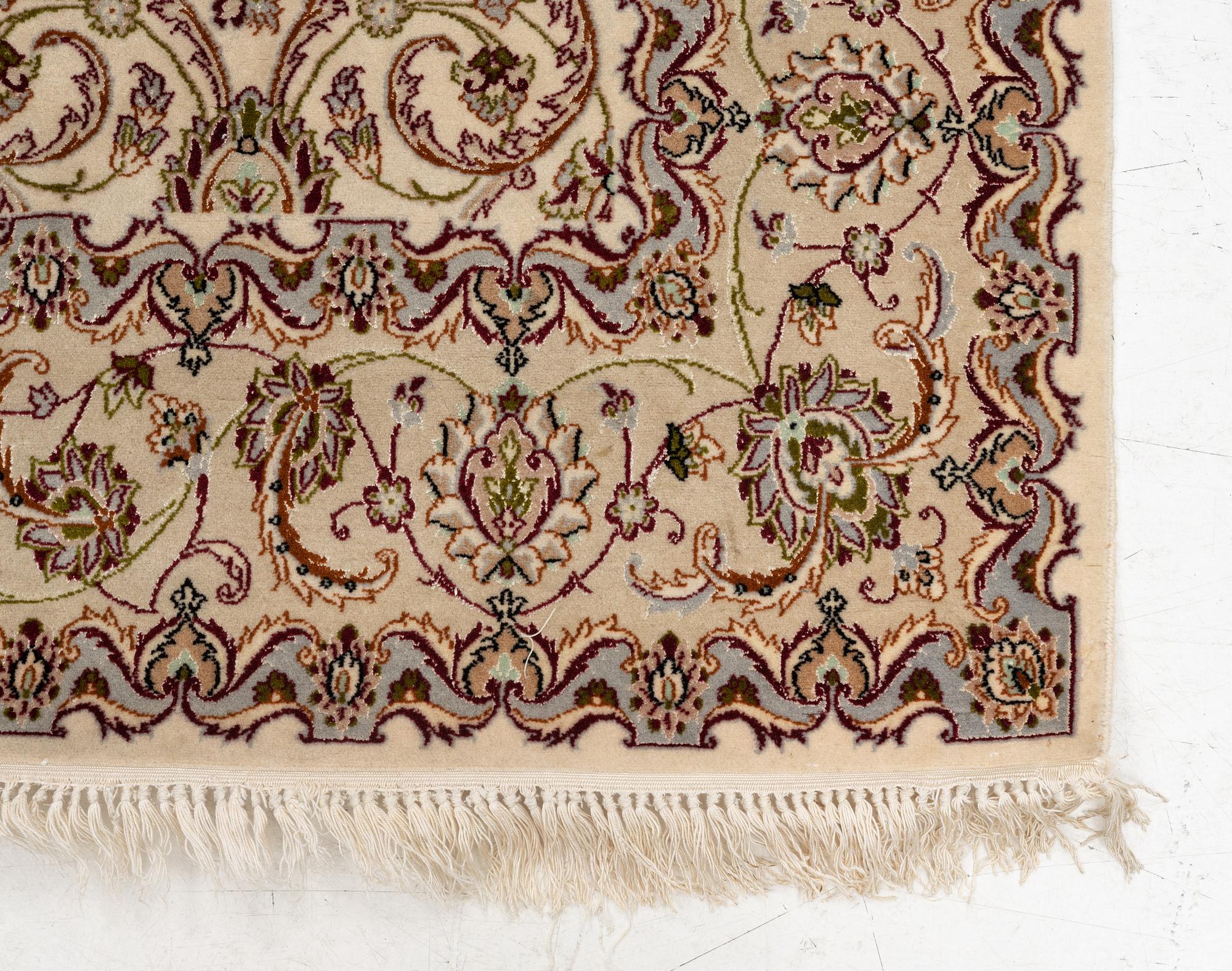 An Isfahan, part silk rug, signed, c. 165 x 112 cm.