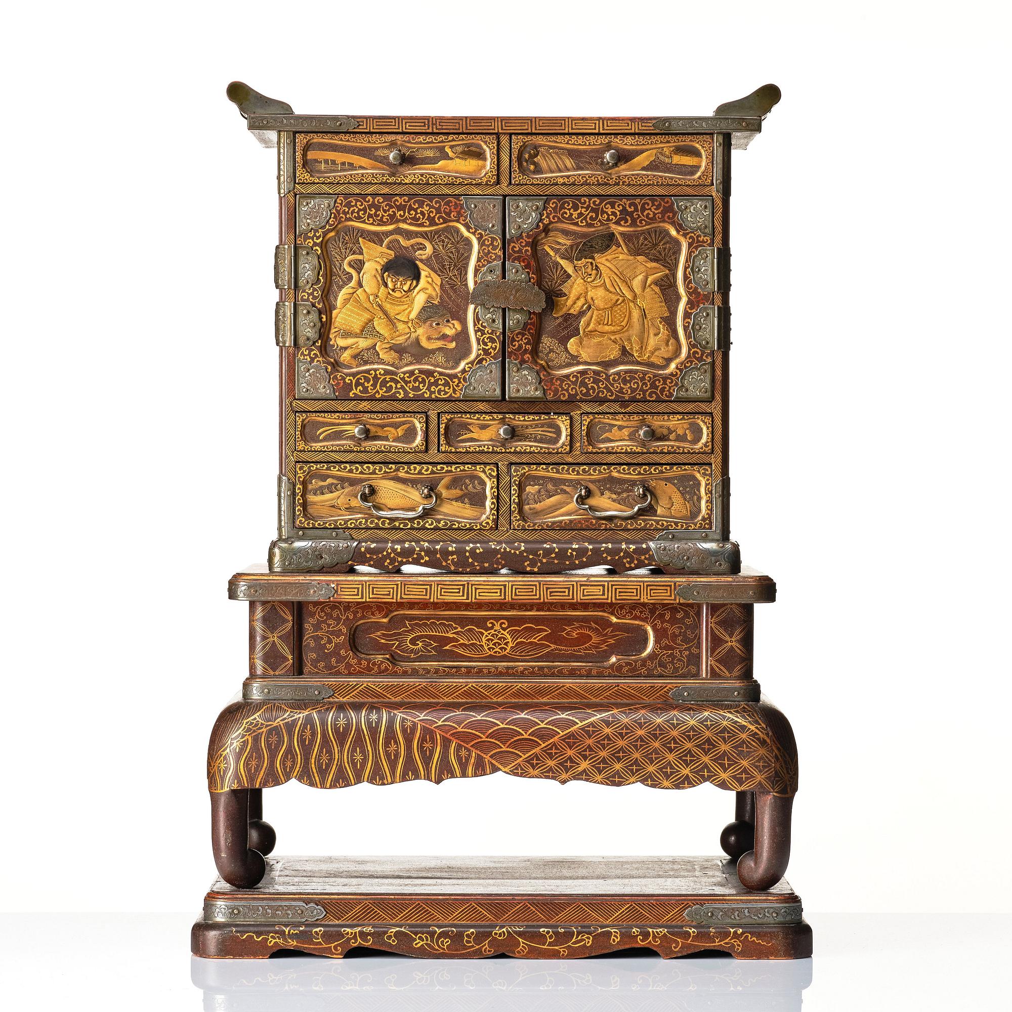 A Japanese lacquer cabinet on a stand, Meiji period (1868-1912).