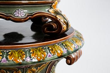 A pot on a pedestal in ceramics made by Rörstrand in the years between 1884-1890.