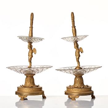 A pair of French Empire early 19th century gilt bronze and glass centre pieces in the manner of Pierre Philippe Thomire.