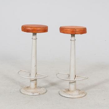 A pair of Necchi leather and metal bar stools later part of the 20th century.