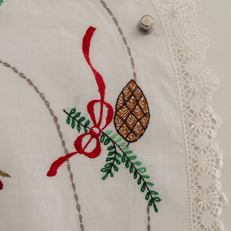 A collection of smaller Christmas tablecloths, runners, and wall hangings, approximately 34 pieces, mid/second half of the 20th century.