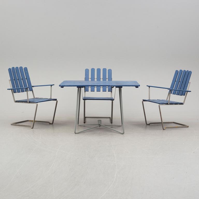 A painted garden table and four armchairs, first half of the 20th century.