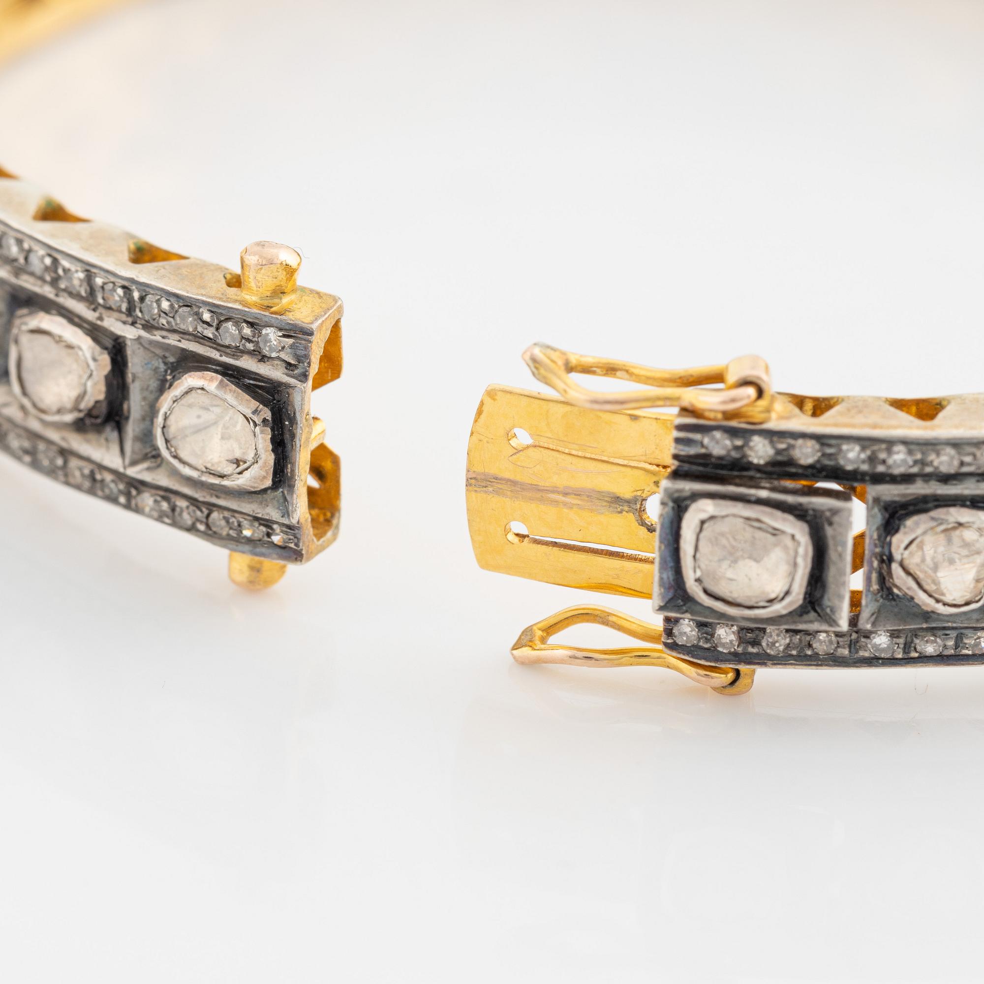 A faceted diamond bangle.