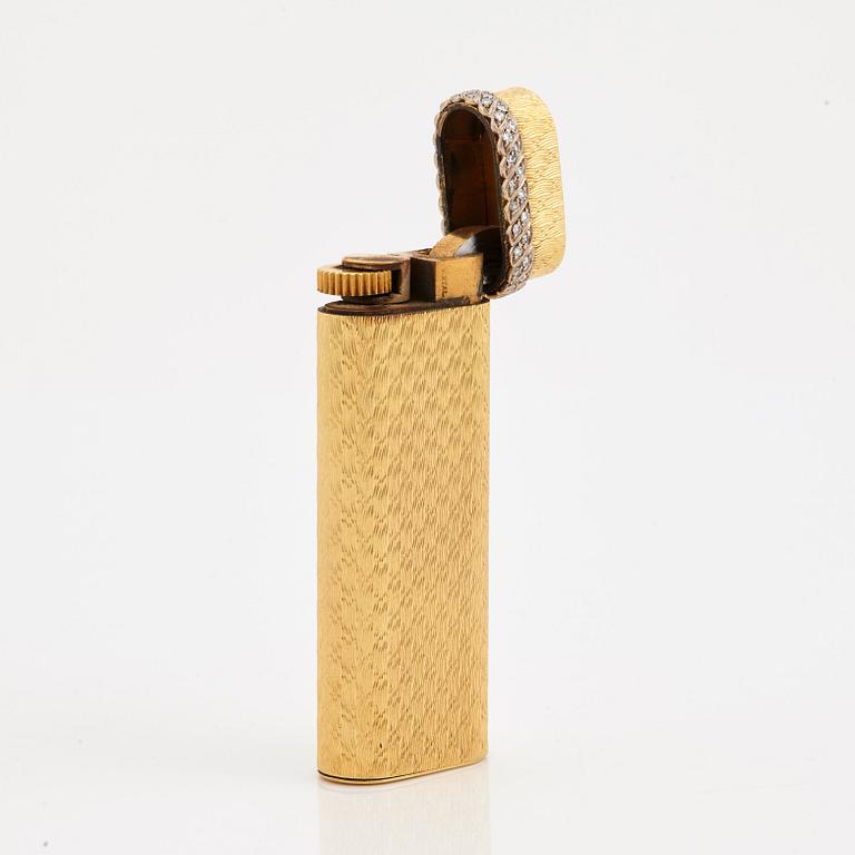 A cigarette lighter by Cartier set with single cut diamonds.