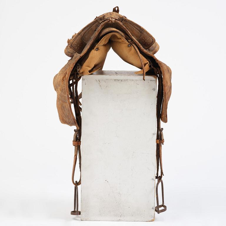 A leather saddle of Caucasian type, dated 1821.