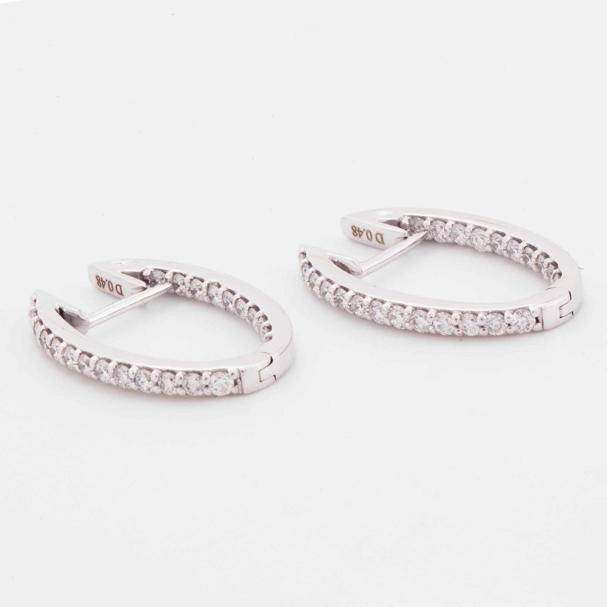 Brilliant-cut diamond hoop earrings.
