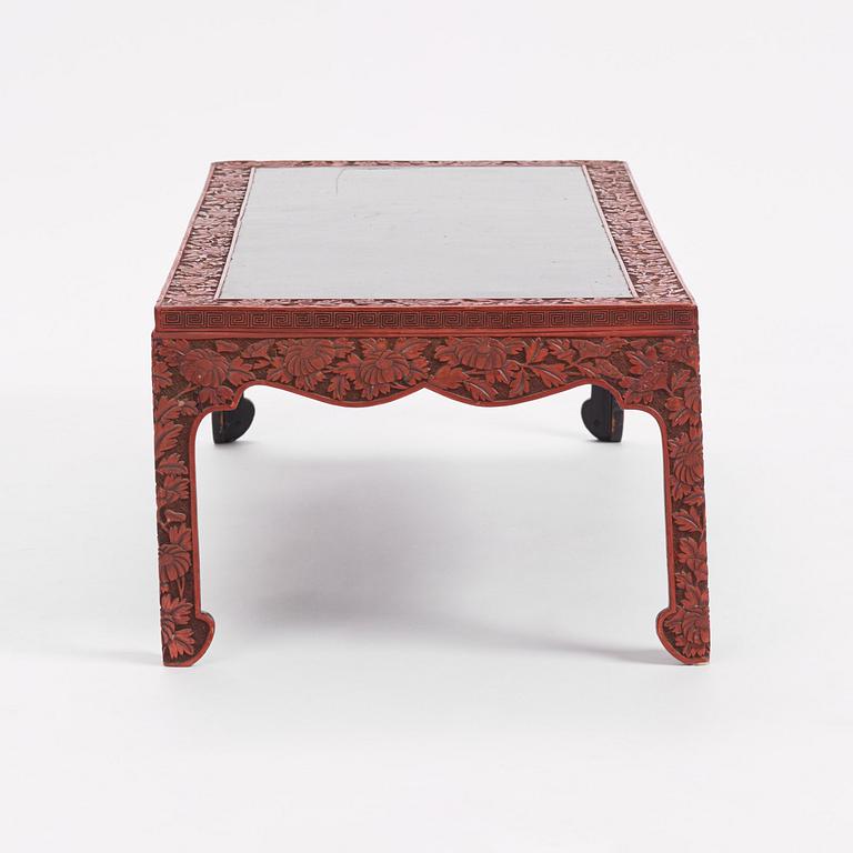 A carved lacquered table, early 20th Century.