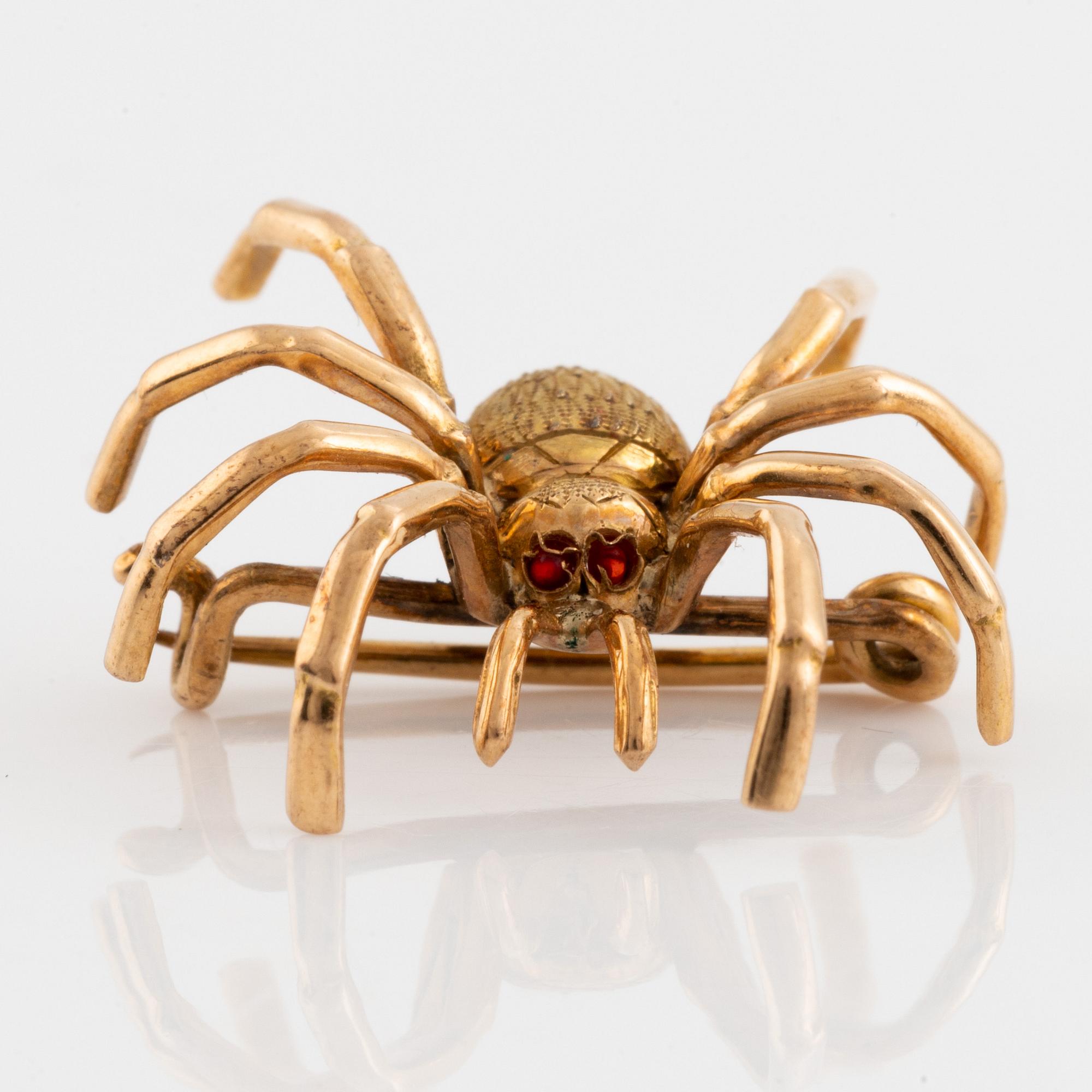 Gold spider brooch.