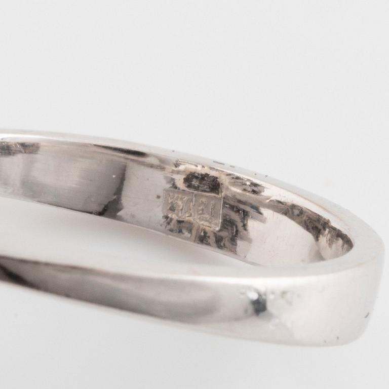 An 18K white gold, navette sapphire and baguette- and round brilliant cut diamond ring.