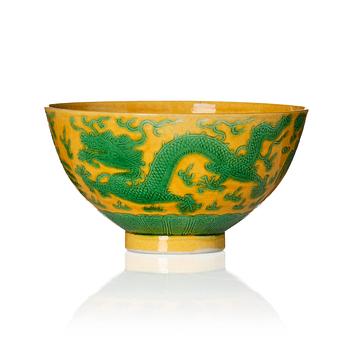 1092. A yellow-ground green-enamelled 'dragon' and phoenix bowl, underglaze blue Daoguang seal mark and of the period.