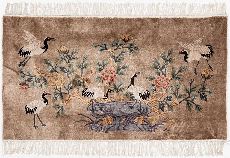A silke figural rug, China, later part of the 20th century, ca. 92 x 170 cm.