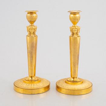 A pair of gilt-bronze Emnpire style candlesticks in the manner of Claude Galle, 19th century.