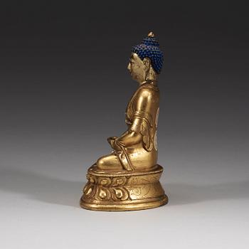 A seated Sino-Tibetan part gilt bronze figure of Amithaba Buddha, 18th Century.