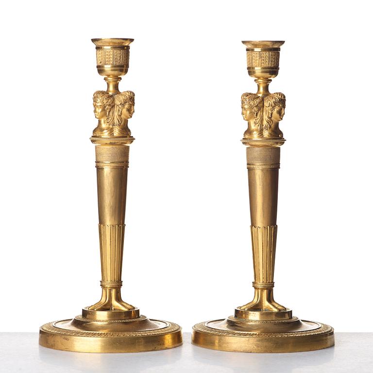 A pair of French Empire early 19th century gilt bronze candlesticks.