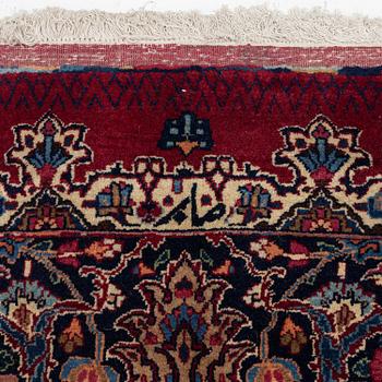 A Mashad carpet, signed Saber, c. 468 x 348 cm.