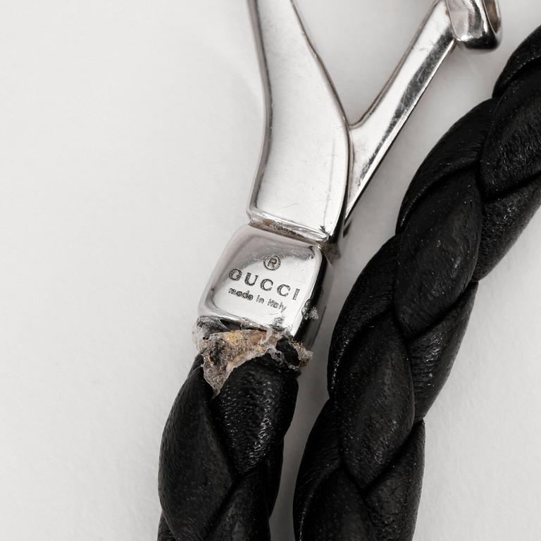 GUCCI. a black leather bracelet.