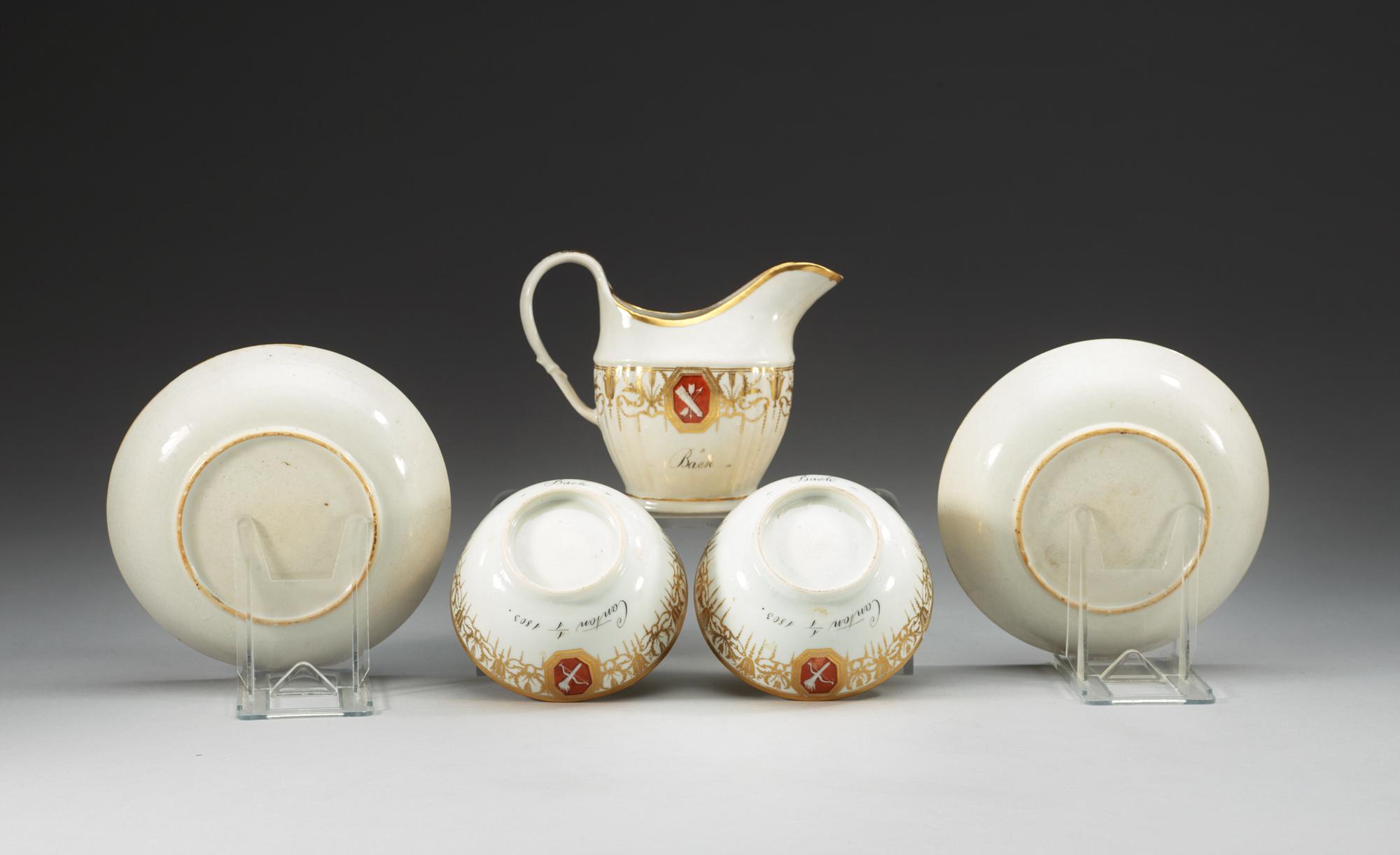 Two armorial tea cups with saucers and a creamer, Qing dynasty, Jiaqing (1796-1820).