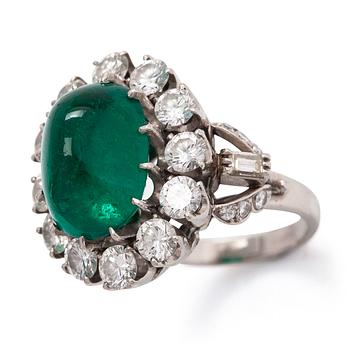 A platinum ring, oval cabochon-cut emerald approx. 8.50 ct, and diamonds totalling 2.84 ct according to certificate.