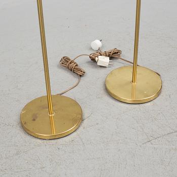 A pair of brass floor lamps, "MAE 27".