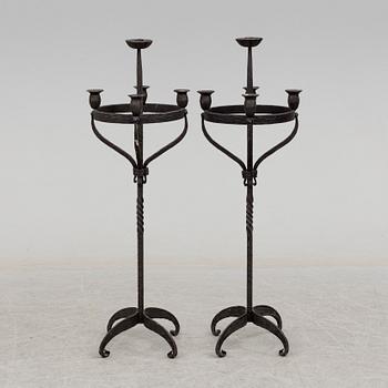 a pair of iron floor candle sticks, 20th century.