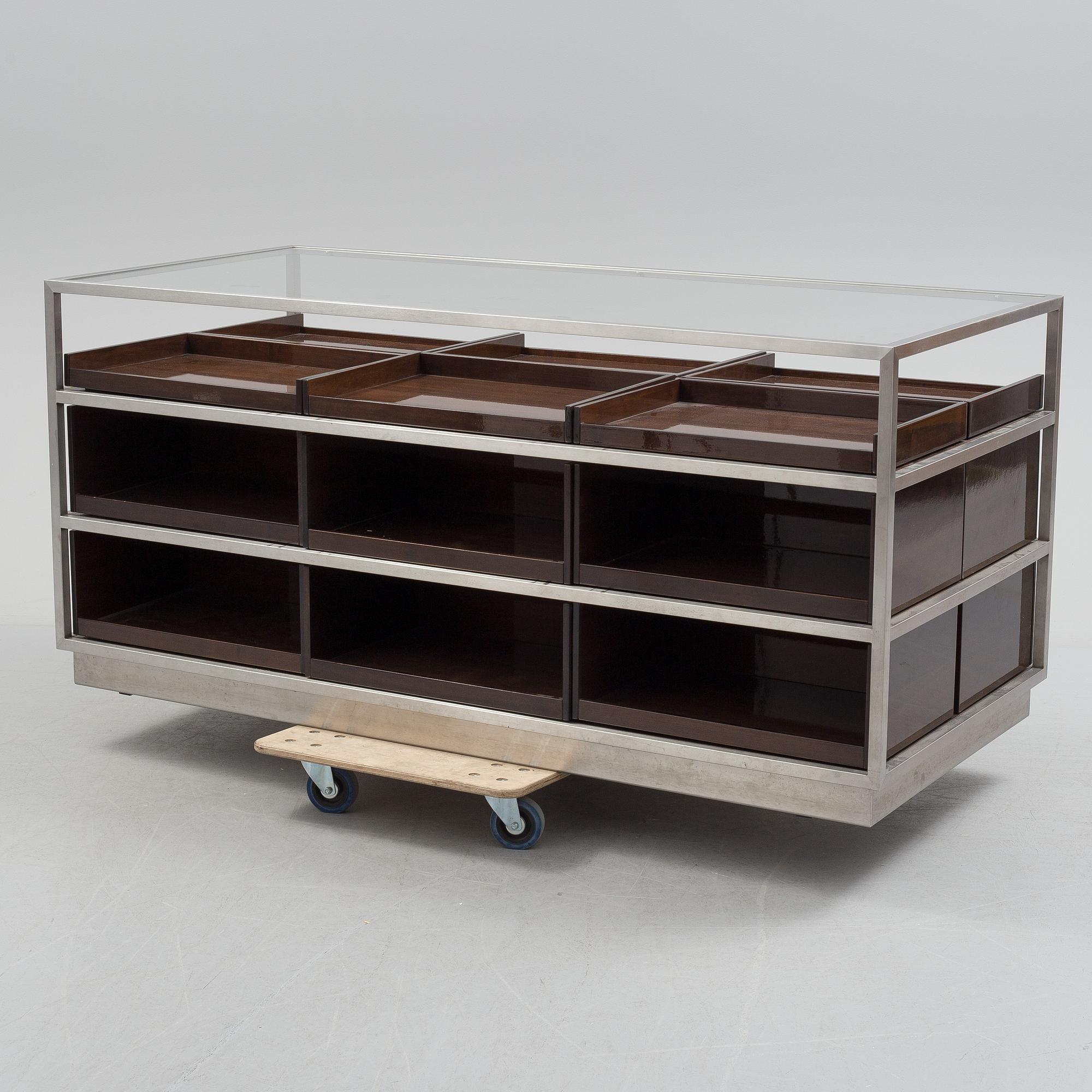 A modern glass and metal cabinet for shop use.