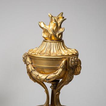 A pair of gilt brass Louis-XVI style andirons, second half of the 19th Century.