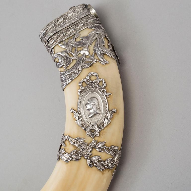 An early 20th century cigar cutter made of a wildboars tusk with silvermountings.