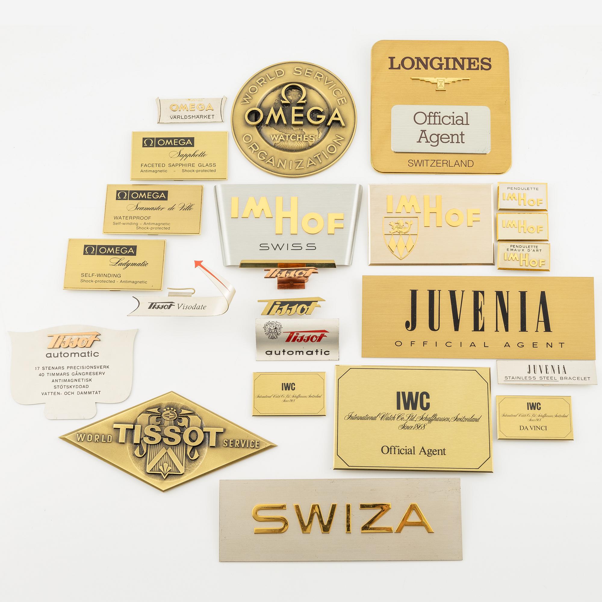A collection of shop signs and agent plaques from Swiss watchmakers.