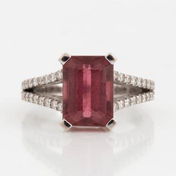 An emerald-cut pink tourmaline and diamond ring.