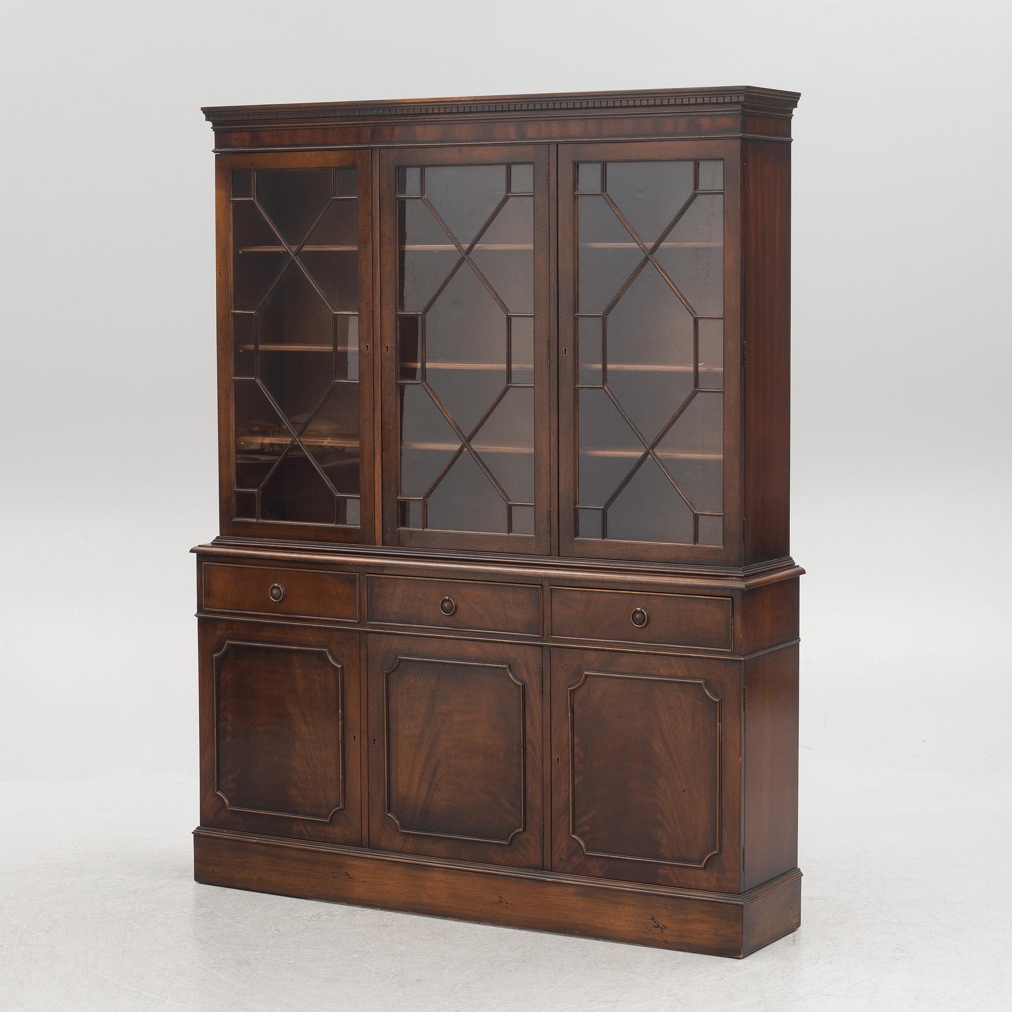 A two-part cabinet, England, mid 20th century.
