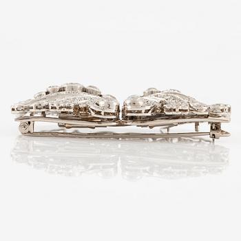 A brooch/double clip in platinum set with old- and eight cut diamonds.