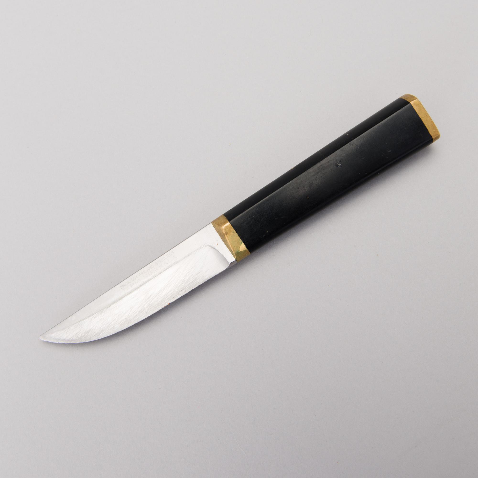 A Finnish puukko knife in stainless steel, nylon and brass