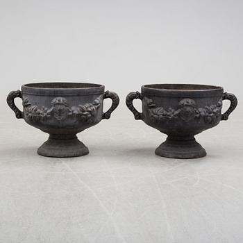 A pair of early 20th century iron garden urns.