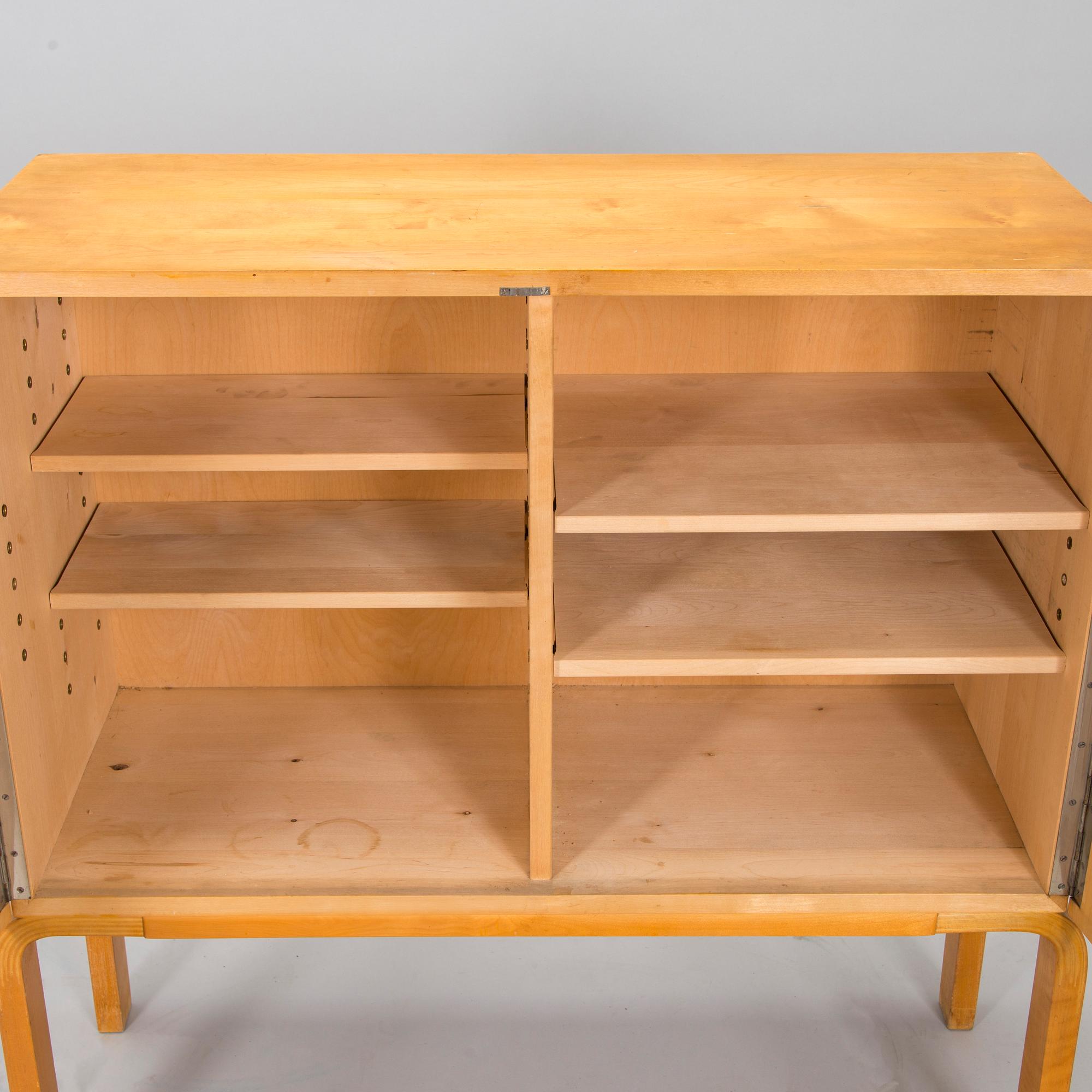 Alvar Aalto, mid-20th century '810' cabinet and a 
'69'chair Oy Huonekalu- ja Rakennustyötehdas Ab.