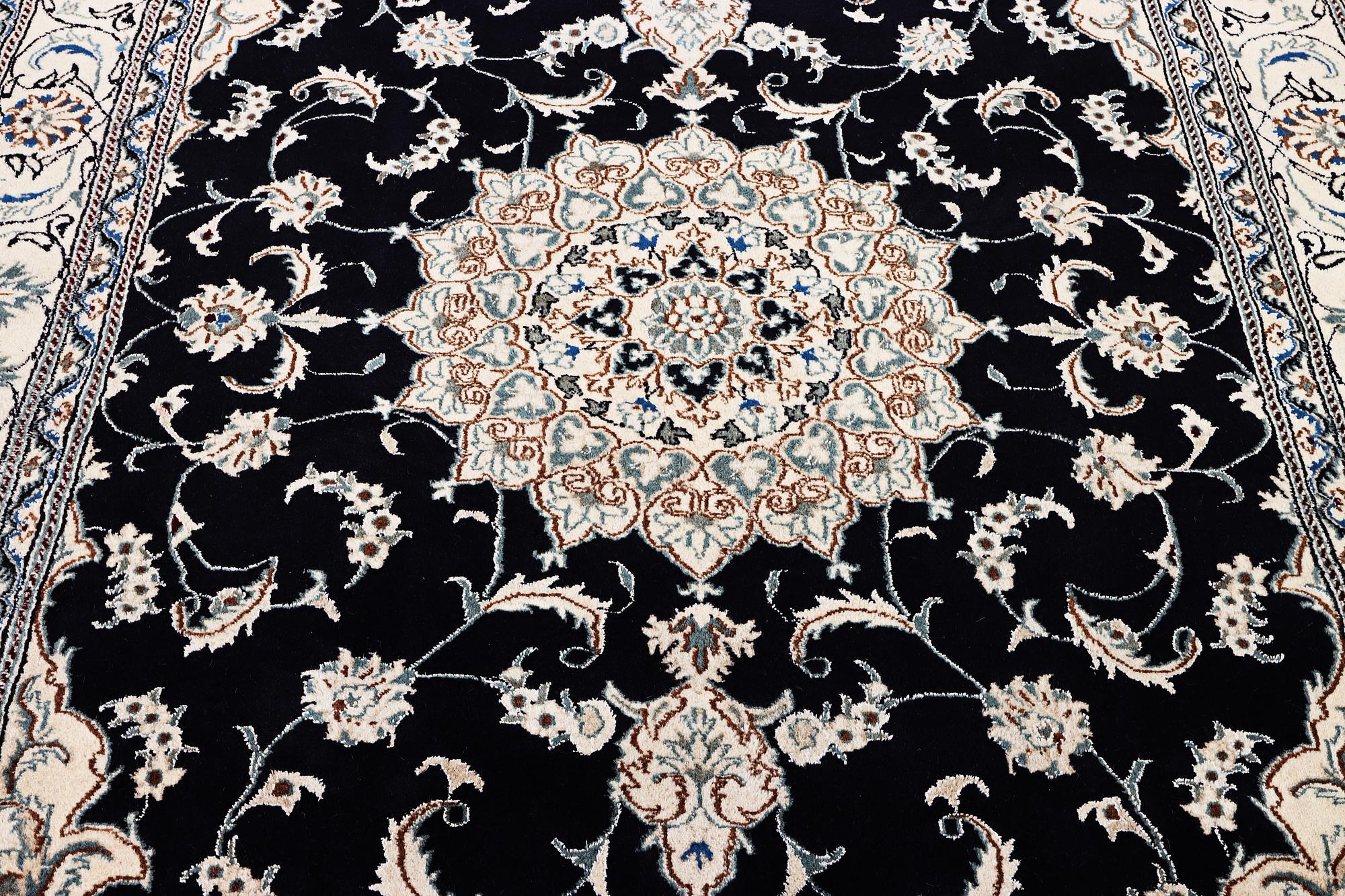A Nain carpet, part silk, c. 303 x 200 cm.