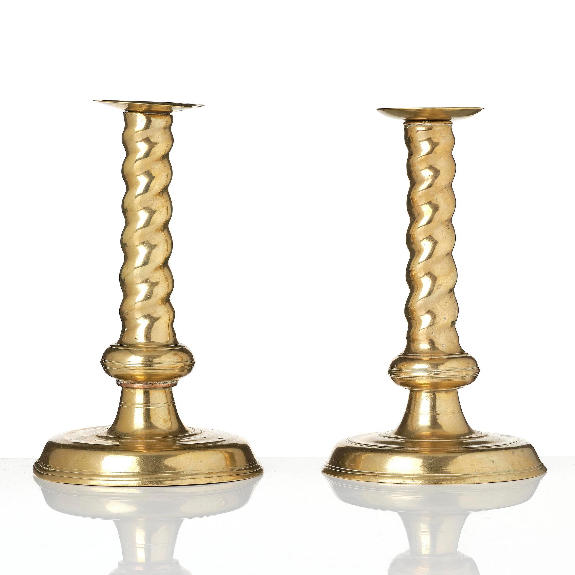 A pair of Northern European cast brass baroque candlesticks, circa 1700.
