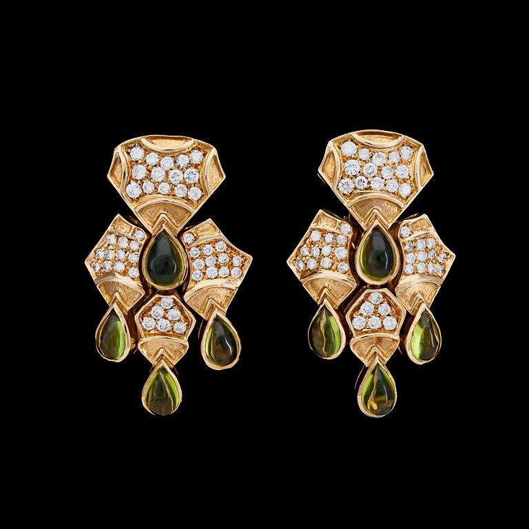 A pair if cabochon cut peridote and brilliant cut diamond earrings, tot. app. 3 cts.
